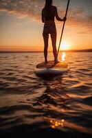 Stand up paddle boarding on quiet sea. photo