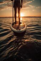 Stand up paddle boarding on quiet sea. photo