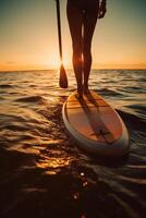 Stand up paddle boarding on quiet sea. photo