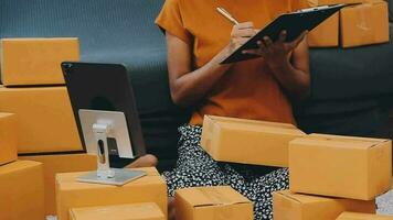 Business woman start up small business entrepreneur SME success .freelance woman working at home with Online Parcel delivery. SME and packaging deliveryconcept video