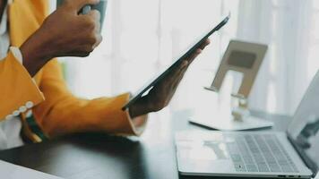 Close up Business woman using calculator and laptop for do math finance on wooden desk, tax, accounting, statistics and analytical research concept video