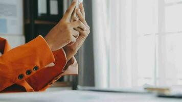 Close up Business woman using calculator and laptop for do math finance on wooden desk, tax, accounting, statistics and analytical research concept video