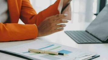 Close up Business woman using calculator and laptop for do math finance on wooden desk, tax, accounting, statistics and analytical research concept video