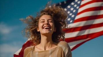 Woman smiling and holding wide waving american flag high in sky. photo