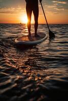 Stand up paddle boarding on quiet sea. photo