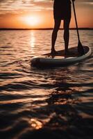 Stand up paddle boarding on quiet sea. photo