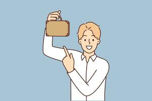 Businessman with miniature briefcase smiling and looking at screen for small business or minority investment concept. Guy in white shirt, owner of small company, points finger at briefcase vector