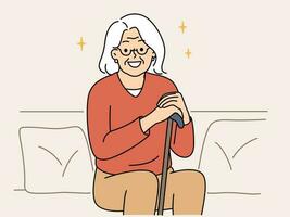 Smiling elderly grandmother sit on sofa with walking stick feeling positive and optimistic. Happy mature woman enjoy good maturity and retirement. Vector illustration.