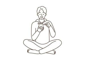 Smiling young man sit on floor using modern smartphone. Happy guy with cellphone browse internet or chat online on social media. Vector illustration.