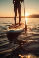 Stand up paddle boarding on quiet sea. photo