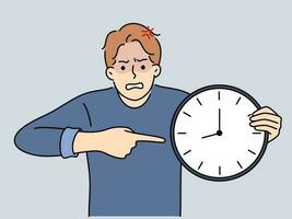 Furious man point at clock stressed with missed deadline. Mad male show with finger on watch distressed with bad time management. Vector illustration.