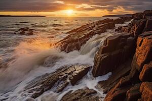 The waves are crashing over the rocks at sunset. photo