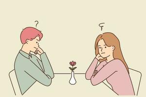 Unhappy man and woman sit at table in restaurant at first date feeling confused and stressed. Frustrated couple at cafe have fight or disagreement. Vector illustration.