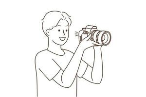 Smiling young man with professional camera taking pictures. Happy guy photographer working with equipment. Photography. Vector illustration.