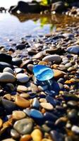 blue transparent pebbles on the beach. photo