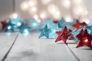 Christmas background with blue light luminous garlands and red stars on a white wooden background with copy space. photo