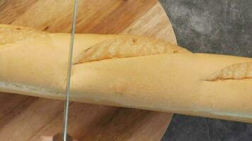 snijdend een brood met een mes Aan een hakken bord video