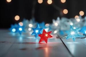 Christmas background with blue light luminous garlands and red stars on a white wooden background with copy space. photo