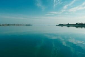 A scene in which the entire light blue sky is reflected in the water. photo