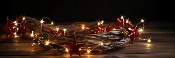 Christmas background with blue light luminous garlands and red stars on a white wooden background with copy space. photo