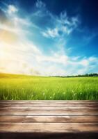 Spring summer beautiful background with green juicy young grass and empty wooden table in nature outdoor. Natural template landscape with blue sky and sun. photo