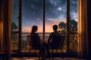 el espalda de un Pareja sentado por el hotel ventana, el ver mediante el ventana es un estrellado noche. ai generativo foto