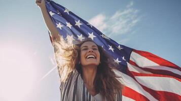 Woman smiling and holding wide waving american flag high in sky. photo