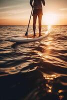 Stand up paddle boarding on quiet sea. photo