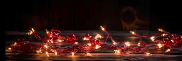 Christmas background with blue light luminous garlands and red stars on a white wooden background with copy space. photo