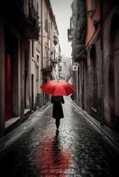 Red umbrella in hand of woman walking on a colorless street. photo