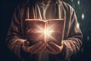 Man is holding and hugging the bible on his chest with atmosphere light. photo