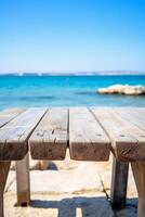 Wooden table blurred Croatian sea in Vodice background. photo