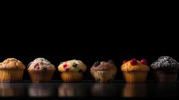 A collection of various flour muffins in a row, black background, isolated. . photo