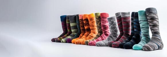 Collection of different patterns of color socks in a row, white background. . photo