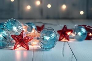 Christmas background with blue light luminous garlands and red stars on a white wooden background with copy space. photo
