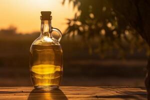 Golden olive oil bottle on wooden table olive field in morning sunshine. photo