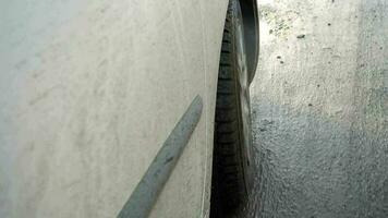 Car tire splashing in muddy puddle video