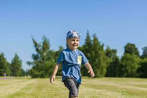 Portrait of a boy, smiling with joy. I am happy to walk in the park in warm sunny weather. photo