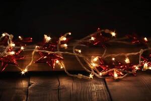 Christmas background with blue light luminous garlands and red stars on a white wooden background with copy space. photo