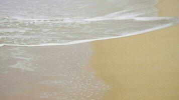 Waves on a sandy beach. May Khao beach in the north of Phuket, slow motion video