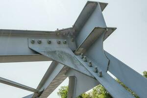 tornillos y nueces en metal platos de acero estructura de pesado deber Derecho travesaño de marco y puente apoyo foto