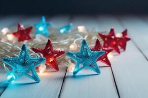 Christmas background with blue light luminous garlands and red stars on a white wooden background with copy space. photo