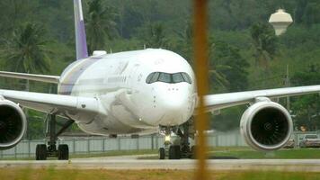 PHUKET, THAILAND NOVEMBER 26, 2017 - Thai Airways Airbus 350 HS THB taxiing after landing, close up of airplane, engine and gear video