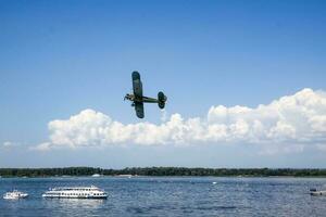 Samara, Russia, 2016-07-31, Holiday of the Navy. Showing military vehicles in action. Reconstruction of the fighting on the Volga River. A plane in the sky. photo