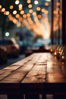 Image of wooden table in front of abstract blurred background of restaurant lights. photo