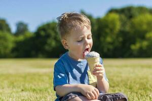 A happy boy is eating ice cream outdoors in the park. photo