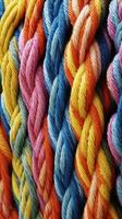 A pattern of multicoloured ropes and twines twisted. photo