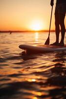 Stand up paddle boarding on quiet sea. photo