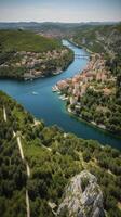 an aerial view of Skradin's historic center, with its winding streets and colorful buildings nestled among the lush greenery. photo