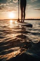 Stand up paddle boarding on quiet sea. photo